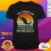 Alt Text: Retro 'I'M Tired Of Waking Up And Not Being In Mexico' sunset t-shirt design featuring vibrant colors and a beach vibe.
