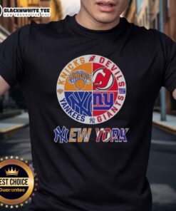 Alt Text: Original New York City Sports T-Shirt featuring Knicks, Devils, Giants, and Yankees logos for fans of NYC teams.