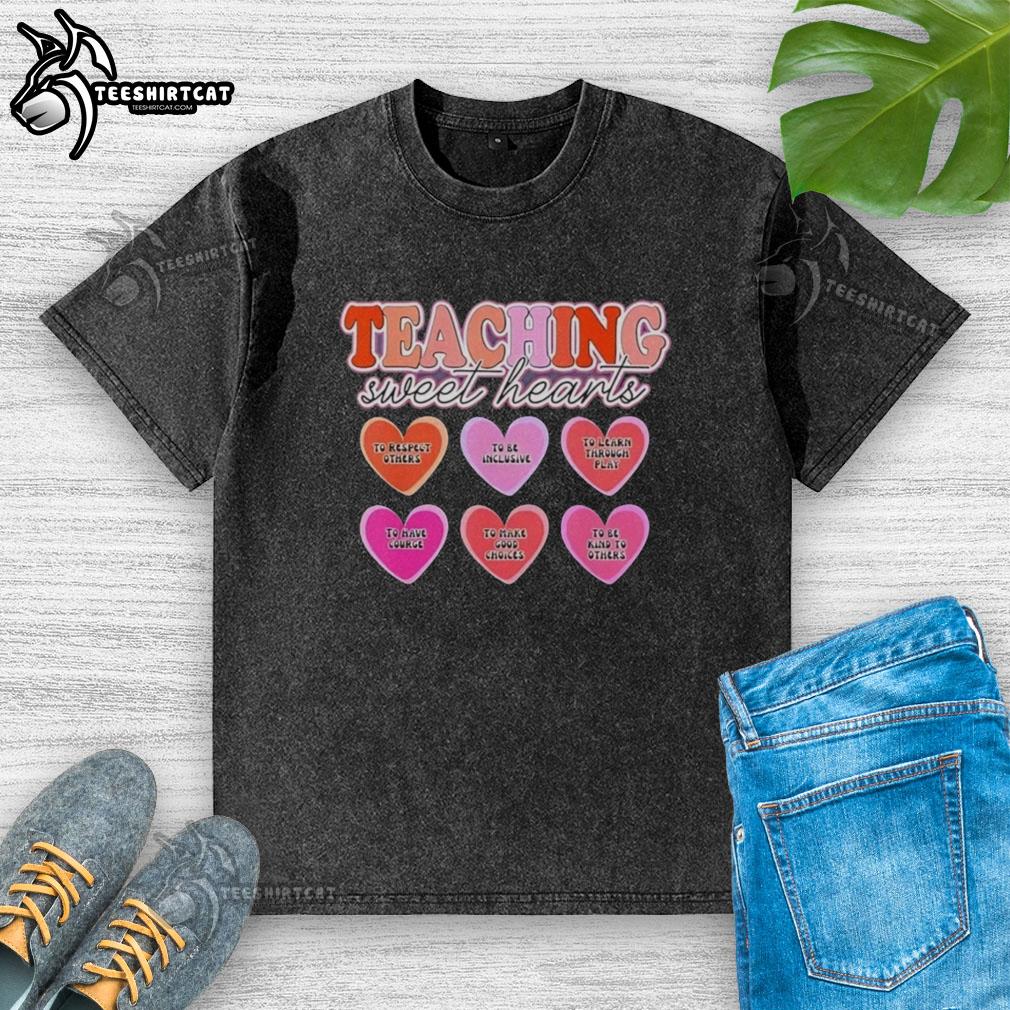 original-teaching-sweet-hearts-to-respect-others-to-be-inclusive-to-learn-through-play-washed-t-shirt Child wearing a washed t-shirt promoting inclusivity and respect, learning through play in a vibrant classroom setting.