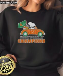 Alt Text: Premium 2025 Goodyear Cotton Bowl Classic Champions sweatshirt featuring Snoopy driving a car for Miami Hurricanes football.