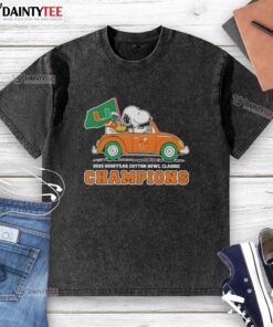 Premium 2025 Goodyear Cotton Bowl Classic Champions tee with Snoopy driving a car, featuring Miami Hurricanes football design.