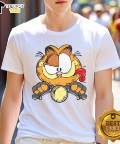 Alt Text: Premium cartoon Garfield cat riding a motorcycle on a stylish T-shirt, perfect for cat lovers and fans of humor.