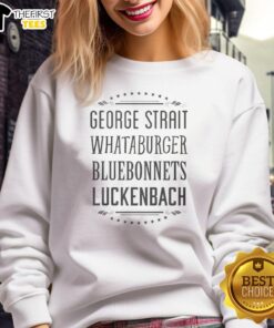 Premium George Strait Whataburger sweatshirt among bluebonnets in Luckenbach, Texas, showcasing Texas pride and style.