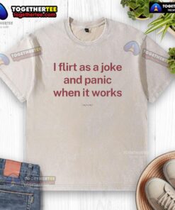 Premium I Flirt As A Joke And Panic When It Works washed t-shirt displayed on a wooden background, stylish and casual.