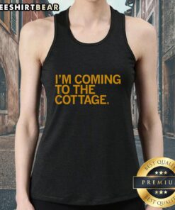 Premium 'I'm Coming to the Cottage' tank top displayed on a rustic wooden background, perfect for summer outings.