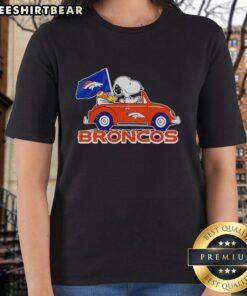 Premium Snoopy and Woodstock driving Denver Broncos football ladies tee featuring vibrant graphics and comfy fit.
