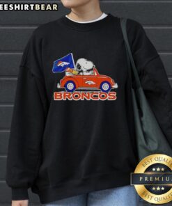 Alt Text: Premium Snoopy and Woodstock driving Denver Broncos football sweatshirt featuring vibrant colors and playful design.