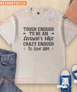 Alt Text: Premium tough enough to be an asshole's wife crazy enough to love him text on a washed t-shirt in light color.