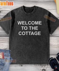Premium Welcome To The Cottage washed t-shirt displayed on a rustic wooden background, showcasing its soft fabric and design.