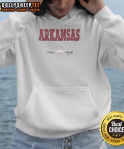 Arkansas Razorbacks football players in Russell Athletic hoodies showcasing team spirit and performance gear on the field.