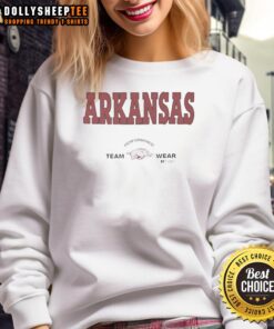 Arkansas Razorbacks football team wearing Russell Athletic sweatshirts during a game, showcasing team spirit and performance.