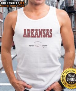Alt Text: Arkansas Razorbacks football team wearing Russell Athletic tank tops during a performance on the field.