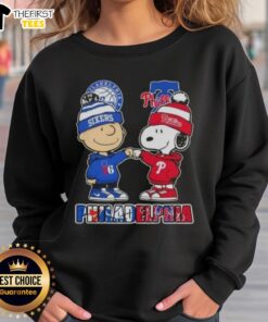 Pretty Charlie Brown fist bump with Snoopy on a Philadelphia City Sports 76ers x Phillies sweatshirt.