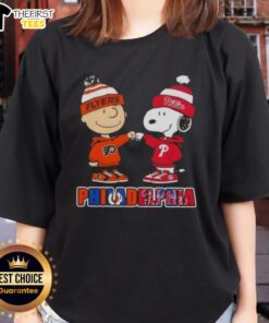 Alt Text: Pretty Charlie Brown fist bump with Snoopy, showcasing Philadelphia City Sports Phillies X Flyers ladies tee.