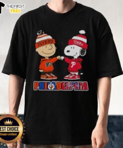 Pretty Charlie Brown fist bump with Snoopy on a Philadelphia sports T-shirt featuring Phillies and Flyers logos.