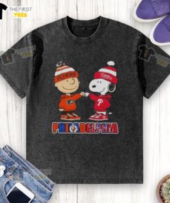Pretty Charlie Brown fist bumping Snoopy in a Philadelphia City Sports Phillies X Flyers washed t-shirt design.
