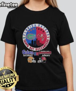 Alt Text: Ladies tee featuring a mashup of Florida Gators and Tampa Bay Buccaneers helmet logos for game day style.
