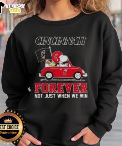 Alt Text: Snoopy driving a car on a Cincinnati Bearcats sweatshirt, promoting Forever, Not Just When We Win theme.