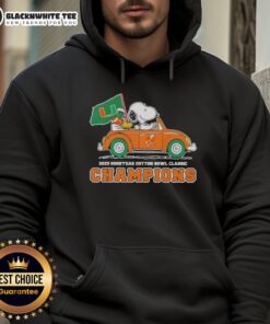 Alt Text: Snoopy driving a car in a Miami Hurricanes football hoodie celebrating the 2025 Goodyear Cotton Bowl Classic champions.