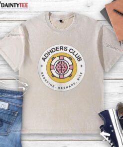 Alt Text: Top Adhders Club Redefine Reshape Rise logo on a washed t-shirt, showcasing a stylish and motivational design.