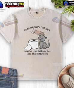 Funny washed t-shirt with 'Top Behind Every Hot Girl Is A Cat That Follows Her Into The Bathroom' graphic design.
