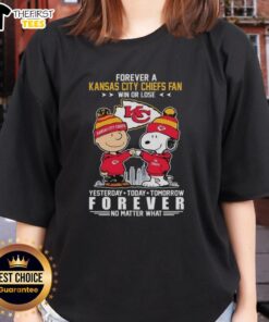 Alt Text: Top Charlie Brown fist bump with Snoopy, celebrating Kansas City Chiefs fandom in a stylish ladies tee.