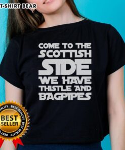 Scottish-themed ladies tee featuring thistle and bagpipes design. Perfect for celebrating Scottish heritage and culture.