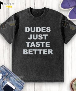 Top Dudes Just Taste Better washed t-shirt displayed on a wooden background, showcasing its trendy design and soft fabric.