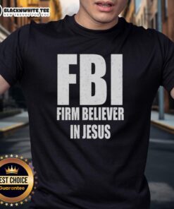 Alt Text: Top FBI Firm Believer In Jesus text T-shirt design featuring bold lettering on a casual shirt.