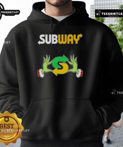 Top Grinch hands holding a Merry Christmas Subway hoodie, perfect for festive holiday wear and celebrating the season.