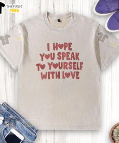 Top I Hope You Speak to Yourself with Love washed t-shirt displayed on a hanger in a bright, airy room setting.
