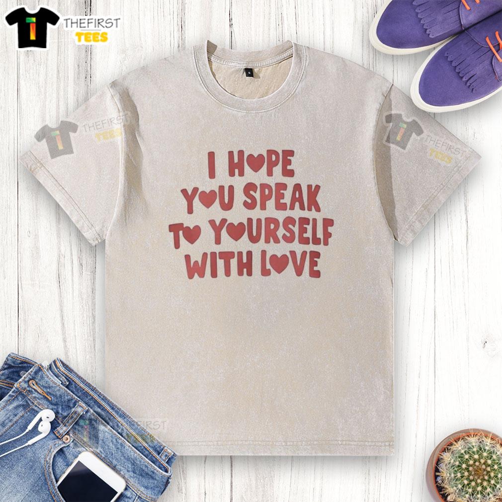 top-i-hope-you-speak-to-yourself-with-love-washed-t-shirt Top I Hope You Speak to Yourself with Love washed t-shirt displayed on a hanger in a bright, airy room setting.
