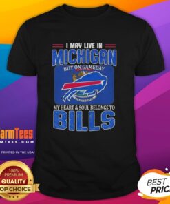 Alt Text: Buffalo Bills football flag t-shirt with 'I May Live In Michigan But My Heart Belongs To Buffalo Bills' slogan.