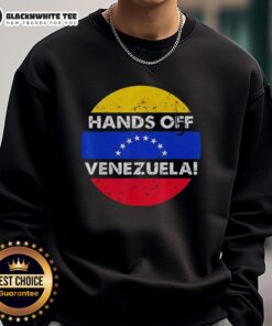Retro sweatshirt featuring 'I Stand With Hands Off Venezuela' design and flag circle, promoting support for Venezuela.