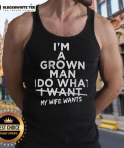 Man wearing a 'Top I'm a Grown Man I Do What I Want My Wife Wants' tank top, showcasing a fun and humorous style.