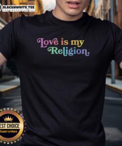 John Pavlovitz wearing a 'Love Is My Religion' T-shirt, promoting patriotism and inclusivity in a vibrant setting.