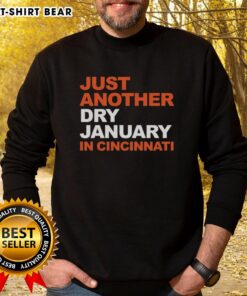 Cozy 'Just Another Dry January in Cincinnati' sweatshirt displayed on a wooden table, perfect for winter style.