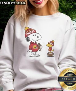 Alt Text: Cozy Kansas City Chiefs Snoopy Woodstock football sweatshirt perfect for NFL fans and chilly game days.