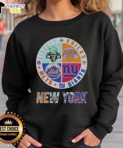 Alt Text: Top New York City Sports sweatshirt featuring logos of Liberty, Knicks, Giants, and Mets for fans.