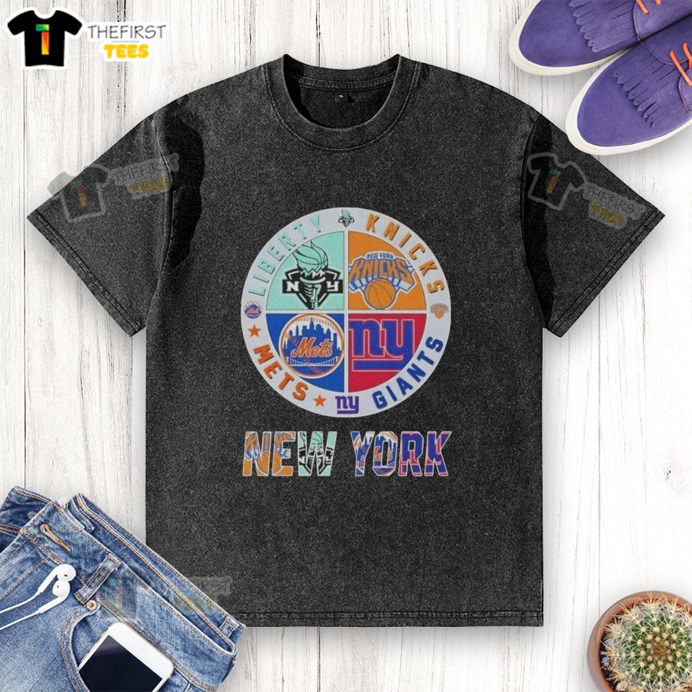 top-new-york-city-sports-liberty-knicks-giants-mets-logos-combine-washed-t-shirt Alt Text: Top New York City sports logos on a washed t-shirt featuring Liberty, Knicks, Giants, and Mets designs.