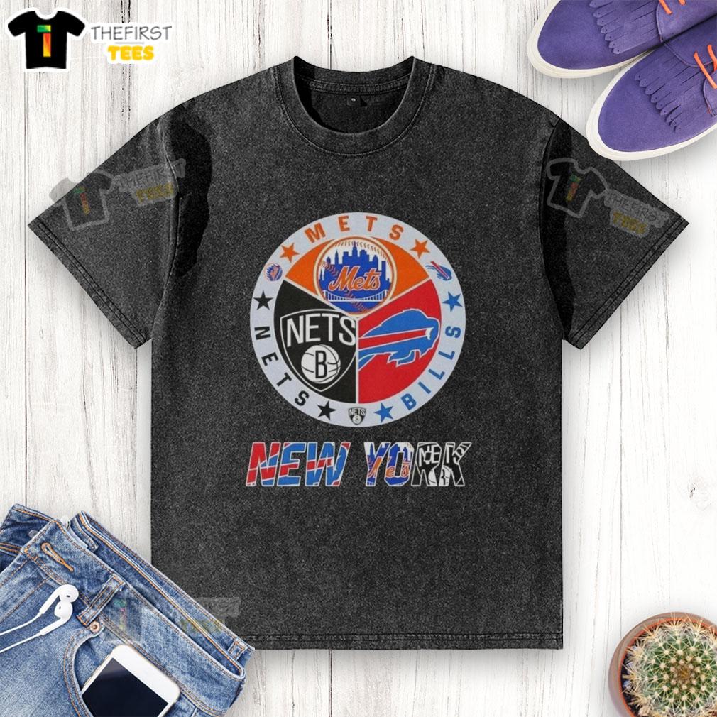 top-new-york-city-sports-mets-bills-nets-logos-combine-washed-t-shirt Alt Text: Top New York City sports logos on a washed T-shirt: Mets, Bills, and Nets for fans of NYC teams.
