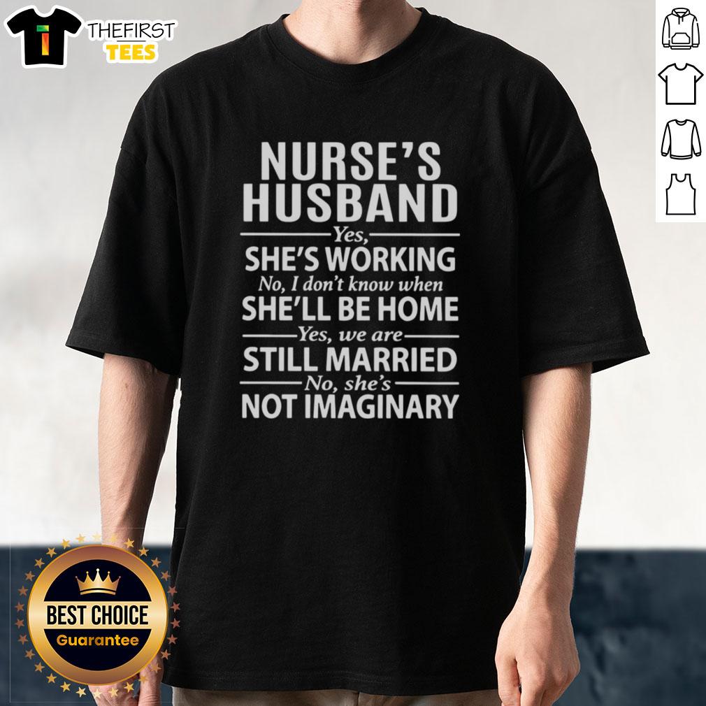 top-nurses-husband-yes-shes-working-no-i-dont-know-when-shell-be-home-t-shirt Alt Text: Top Nurse's Husband T-Shirt: Yes She's Working, No I Don't Know When She'll Be Home - a fun gift for nurse spouses.