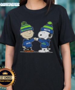 Charlie Brown and Snoopy fist bump in Seattle Seahawks football ladies tee featuring Peanuts characters.