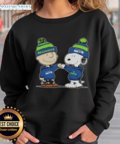 Charlie Brown and Snoopy fist bump in Seahawks sweatshirt, celebrating football spirit in a fun Peanuts design.
