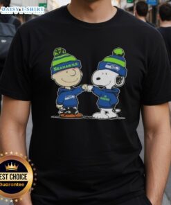 Top Peanuts Charlie Brown fist bump with Snoopy on Seattle Seahawks football T-shirt design. Perfect for fans!