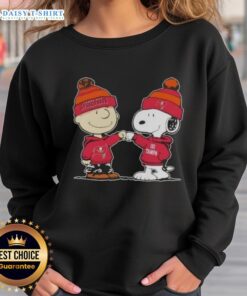 Alt Text: Top Peanuts Charlie Brown fist bump with Snoopy on Tampa Bay Buccaneers football sweatshirt design.