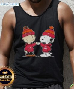 Charlie Brown and Snoopy fist bump in a Tampa Bay Buccaneers tank top featuring top peanuts design.