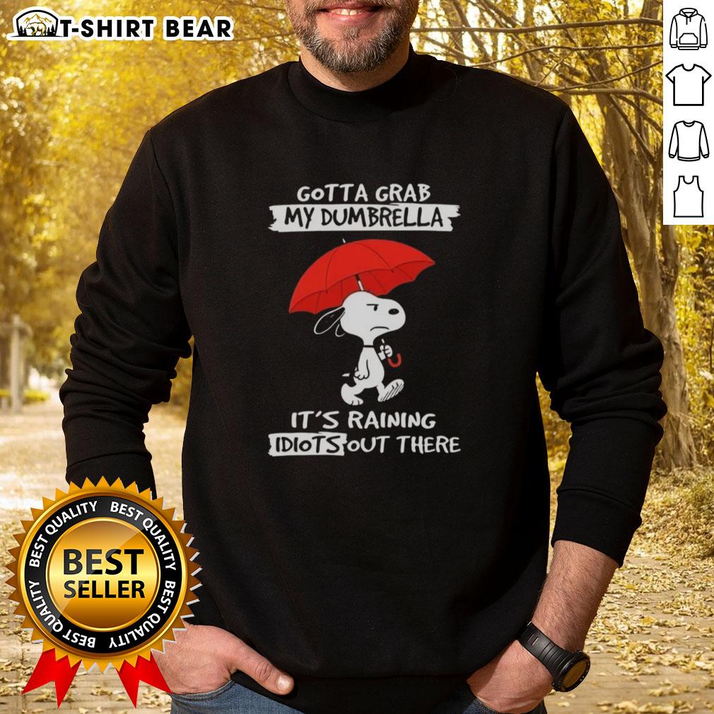 Top Peanuts Snoopy Gotta Grab My Dumbrella It's Raining Idiots Out There Sweatshirt Cozy sweatshirt featuring Snoopy with the phrase 'Gotta Grab My Dumbrella, It's Raining Idiots Out There' perfect for Peanuts fans.