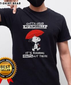 Alt Text: Top Peanuts Snoopy 'Gotta Grab My Dumbrella It's Raining Idiots Out There' T-Shirt featuring Snoopy design.