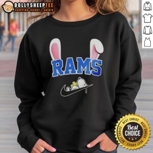 Official Los Angeles Rams X Snoopy Happy Easter Sweatshirt featuring playful design and vibrant colors for festive fans.